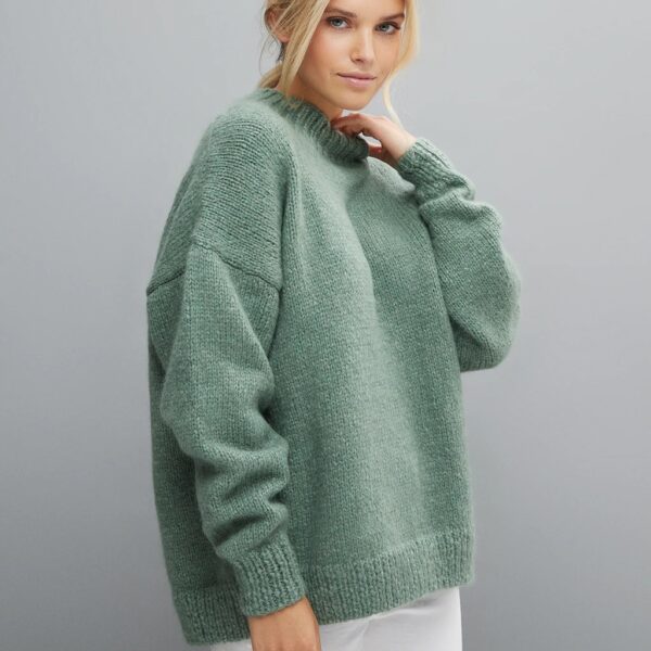 Lady wearing round neck green knitted fluffy jumper